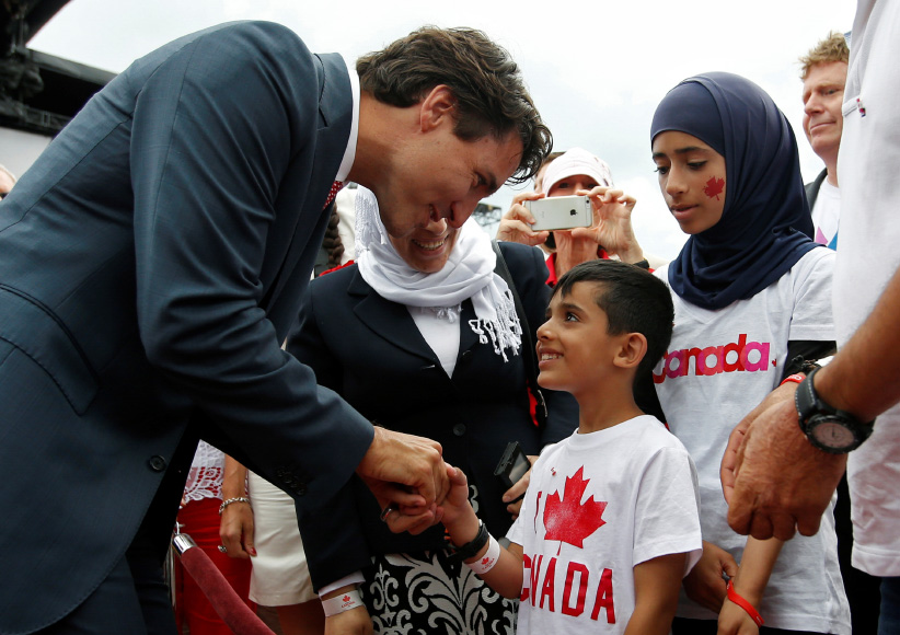 Canada's PM Trudeau shakes hands with a Syrian refugee during Canada Day celebrations on Parliament Hill in Ottawa